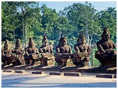 Siem Reap Day One 02  Angkor Thom -a row of  asuras on the right, each row holding a naga in the attitude of a tug-of-war. This appears to be a reference to the myth, popular in Angkor, of the Churning of the Sea of Milk.